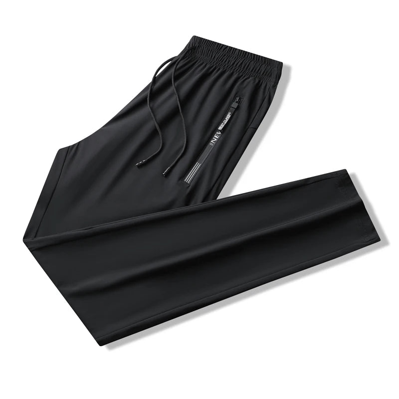 Black men's stretch sweatpants with elastic drawstring waist and side zip pocket, folded flat on white background.
