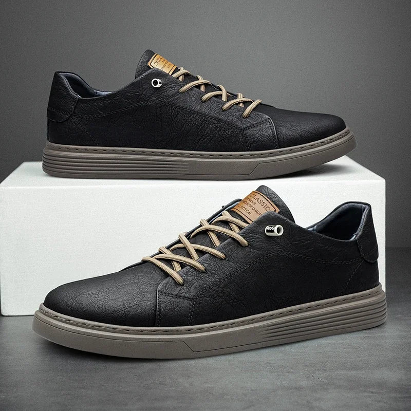 Black leather low-top sneakers for men with beige laces and grey sole on white box