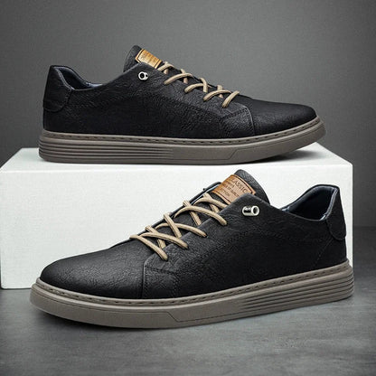 Black leather low-top sneakers for men with beige laces and grey sole on white box