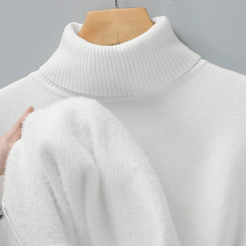 White merino wool turtleneck sweater on mannequin, hand lifting fabric to show soft plush interior lining