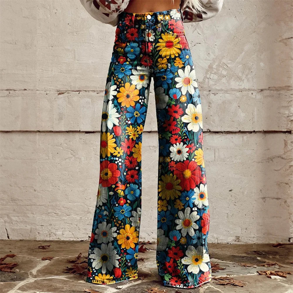 Woman wearing high-waist wide-leg jeans with vibrant multicolor floral print featuring daisies in red, yellow, blue, and white.