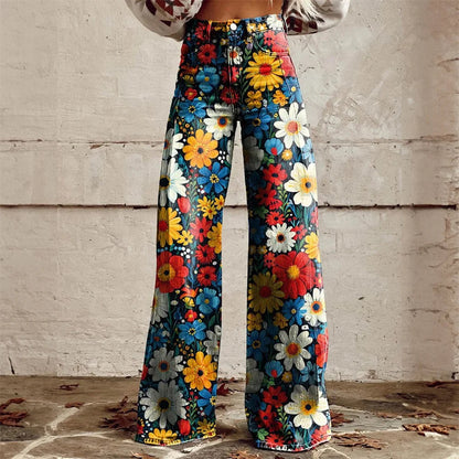 Woman wearing high-waist wide-leg jeans with vibrant multicolor floral print featuring daisies in red, yellow, blue, and white.