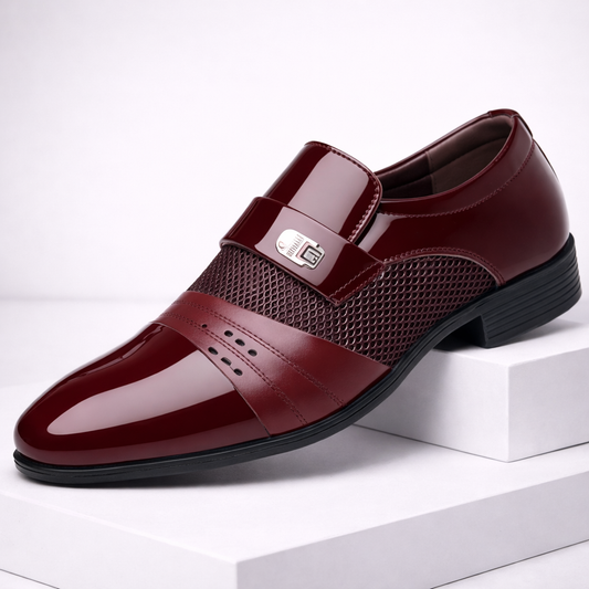 Burgundy patent leather slip-on dress loafers with mesh panel and metal buckle detail for men