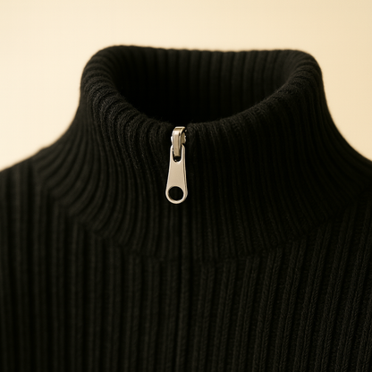 Black wool quarter-zip ribbed turtleneck sweater with silver metal zipper pull, close-up view of collar area.