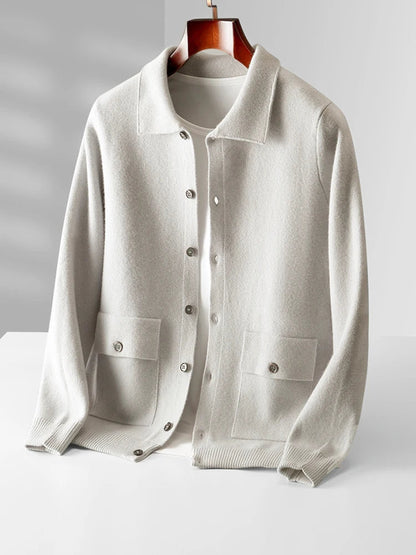 Men's cream merino wool button-up cardigan jacket with collar and front pockets on wooden hanger