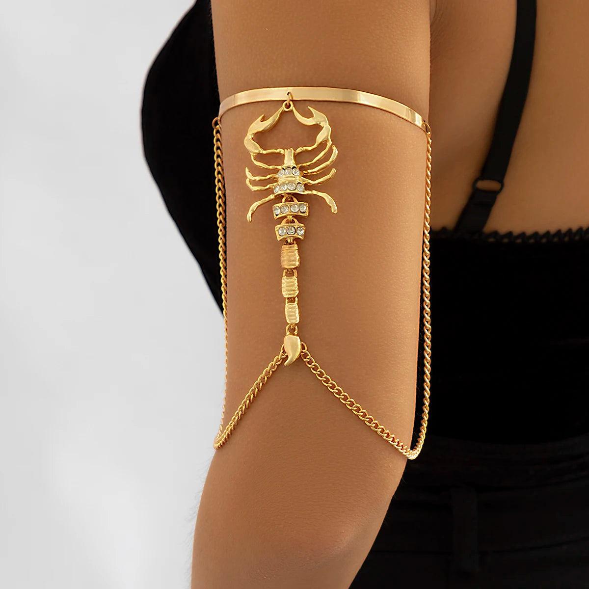 Gold scorpion upper arm cuff bracelet with rhinestones and chain detail for women, edgy statement jewelry