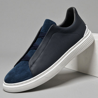 Navy blue men's orthopedic sneakers combining leather and suede panels with elastic laces and white ridged sole.