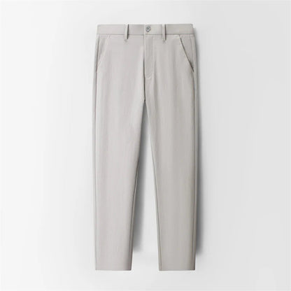 Light gray slim-fit men's dress trousers with front pockets, button closure, and tapered ankle length.