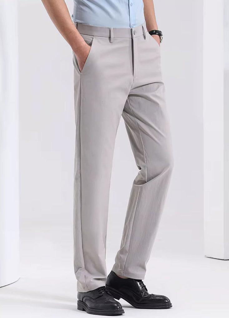Man wearing light gray Viero slim-fit cotton dress trousers paired with a blue shirt and black leather dress shoes.