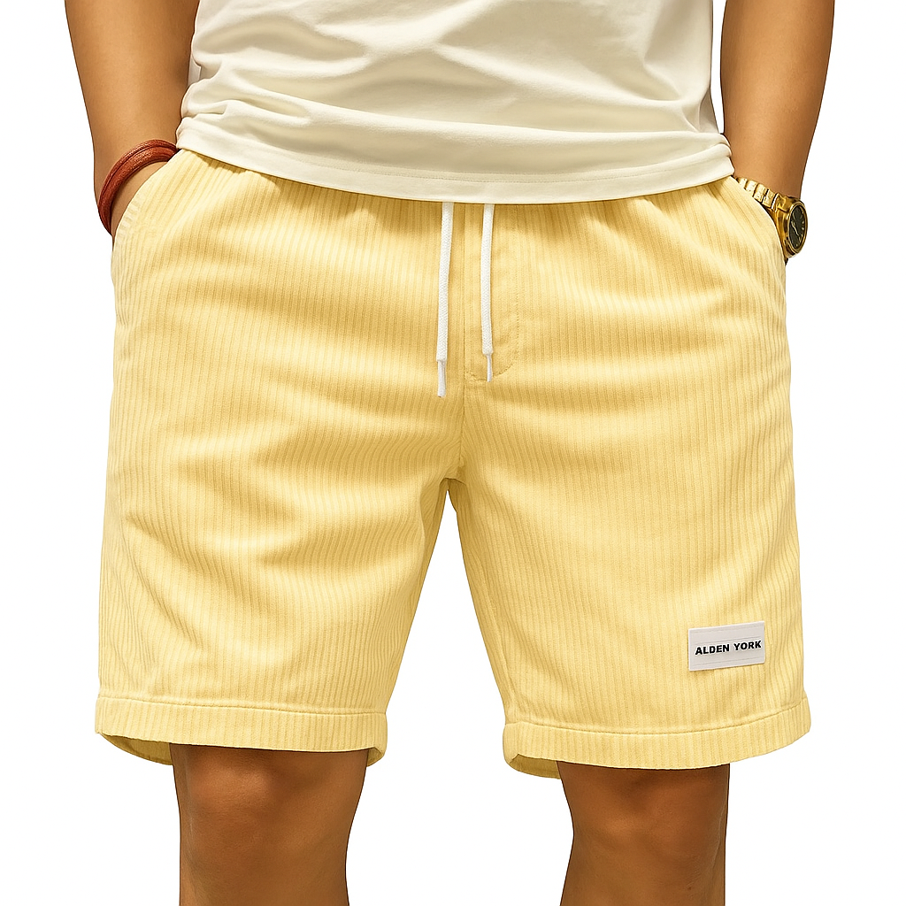 Men's yellow corduroy drawstring shorts with white rope tie, Alden York label, worn with white tee and gold watch.