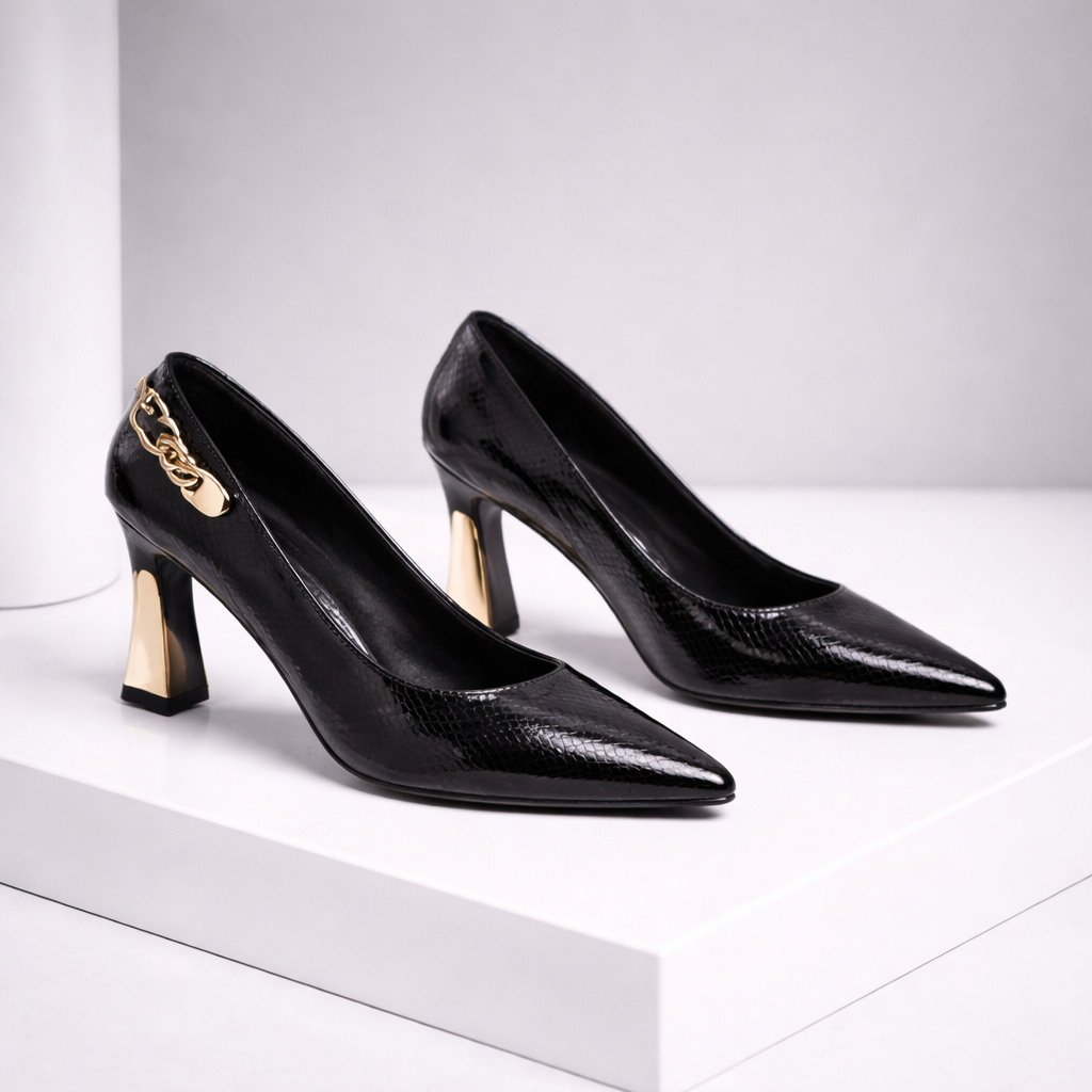 Black Italian leather pointed toe block heel pumps with gold chain detail and snakeskin texture