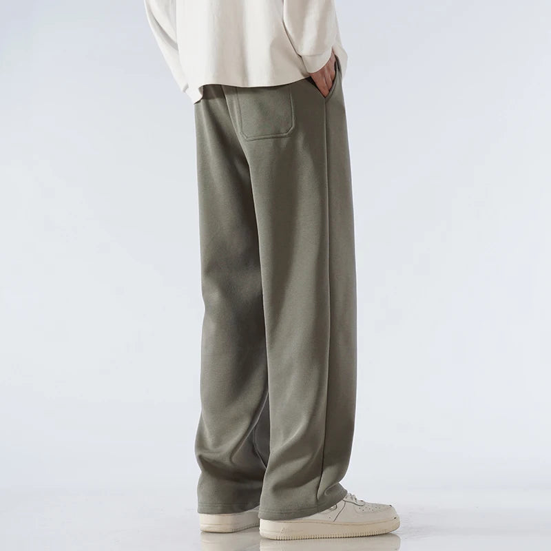 Men's olive green cotton wide-leg relaxed-fit pants with back pocket and elastic waistband, casual streetwear style