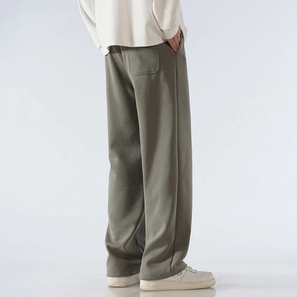 Men's olive green cotton wide-leg relaxed-fit pants with back pocket and elastic waistband, casual streetwear style