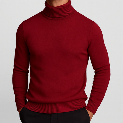 Men's slim-fit merino wool turtleneck sweater in deep red with ribbed cuffs, hem, and collar, paired with black trousers.