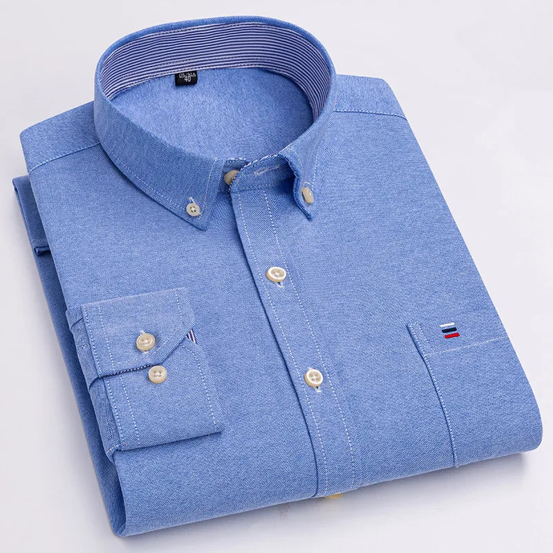 Light blue men's cotton button-down Oxford shirt with chest pocket, cream buttons, and striped collar lining, neatly folded.