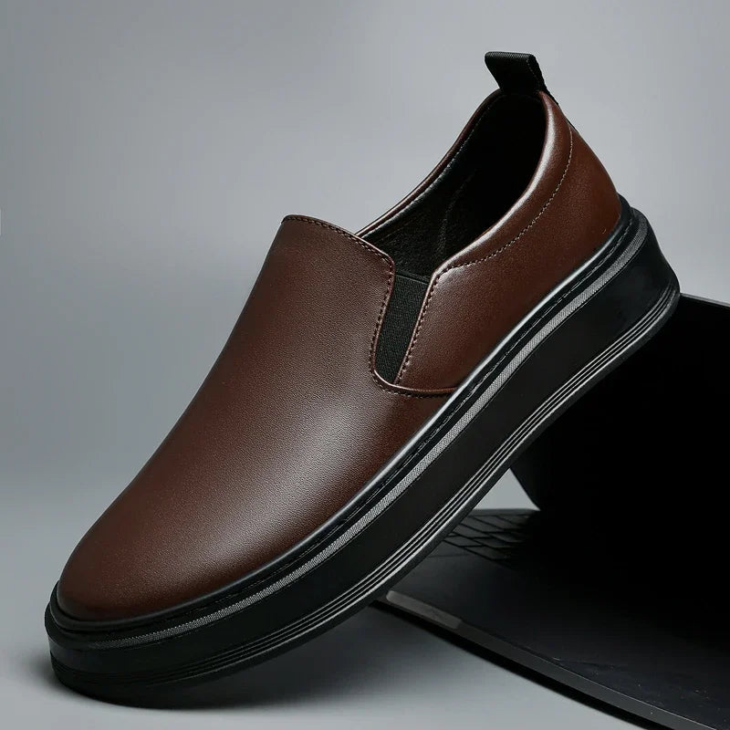 Brown leather slip-on loafers for men with elastic side panels, black interior, and thick platform sole.