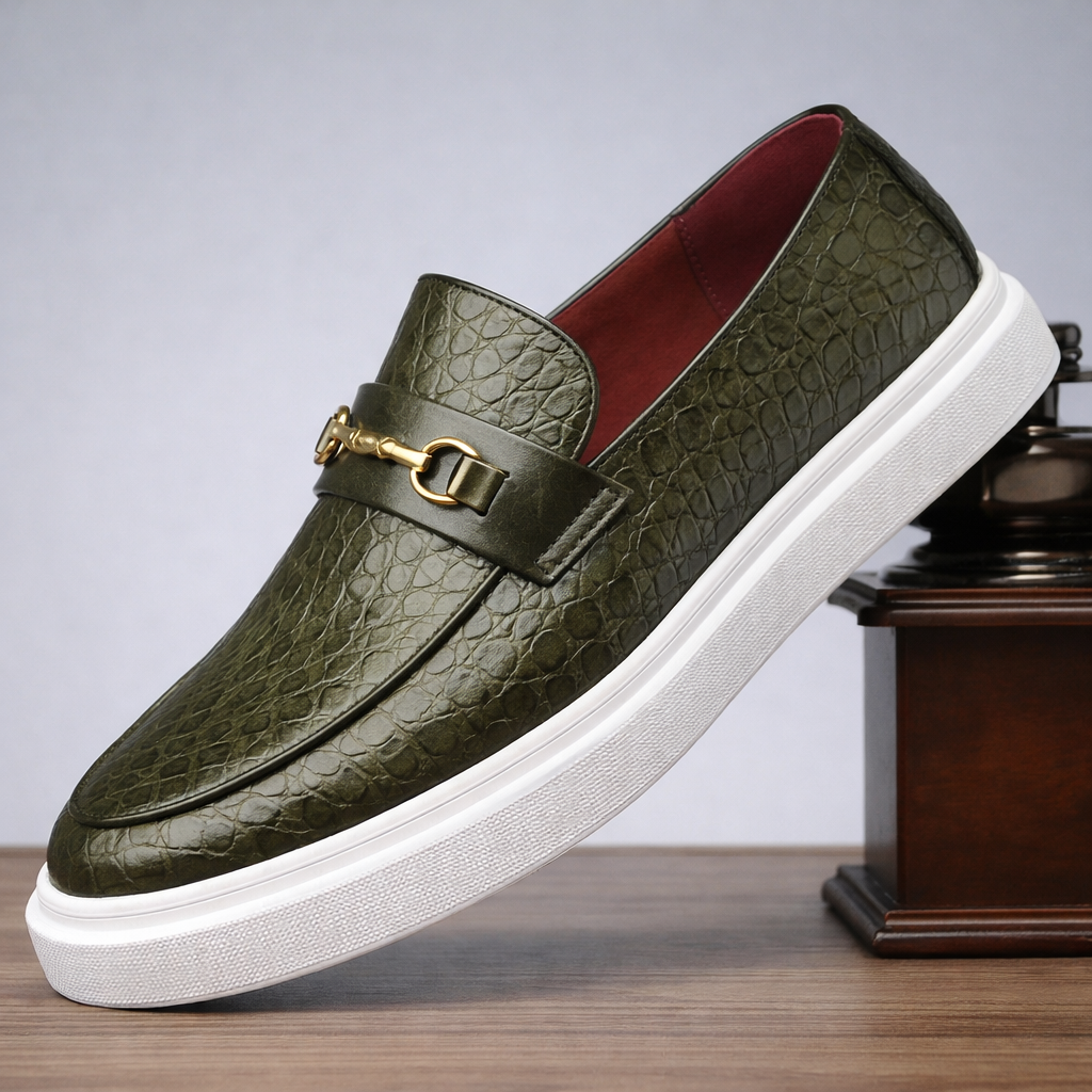 Green croc-embossed leather men's slip-on loafer with gold horsebit buckle, red interior lining, and white platform sole.