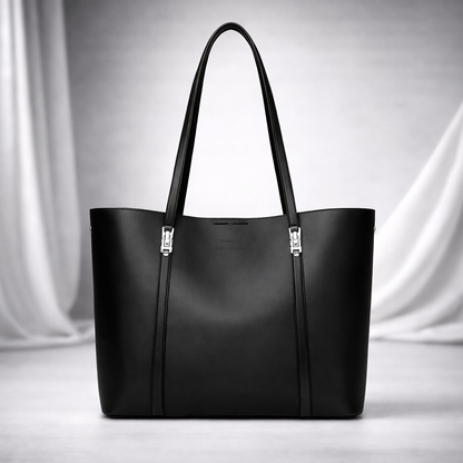 Black leather women's tote handbag with silver hardware buckles and double shoulder straps on white background