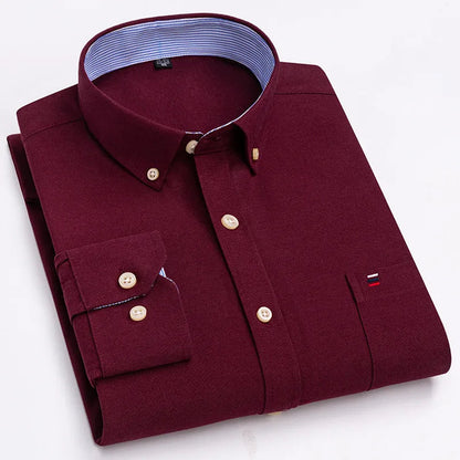 Folded men's cotton button-down shirt in burgundy red with button-down collar and striped inner lining detail.