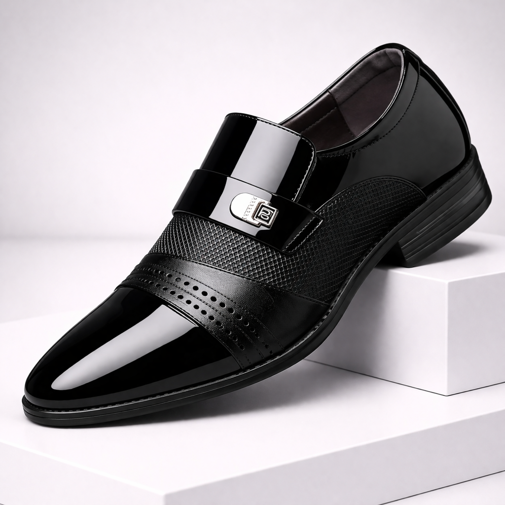 Torreno black patent leather slip-on loafers with metal buckle detail, textured strap, and pointed toe on white display.