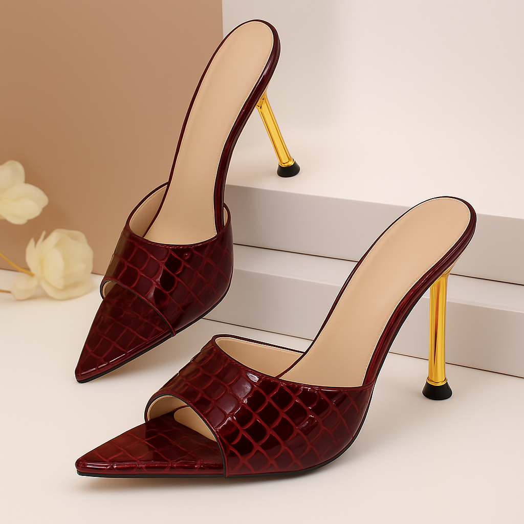 Burgundy croc-embossed open-toe stiletto mule heels with gold metallic heel and beige insole lining.