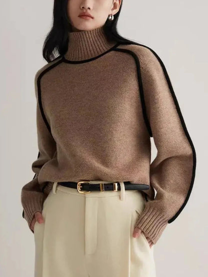 Brown turtleneck ribbed sweater with black contrast piping trim paired with cream trousers and black belt