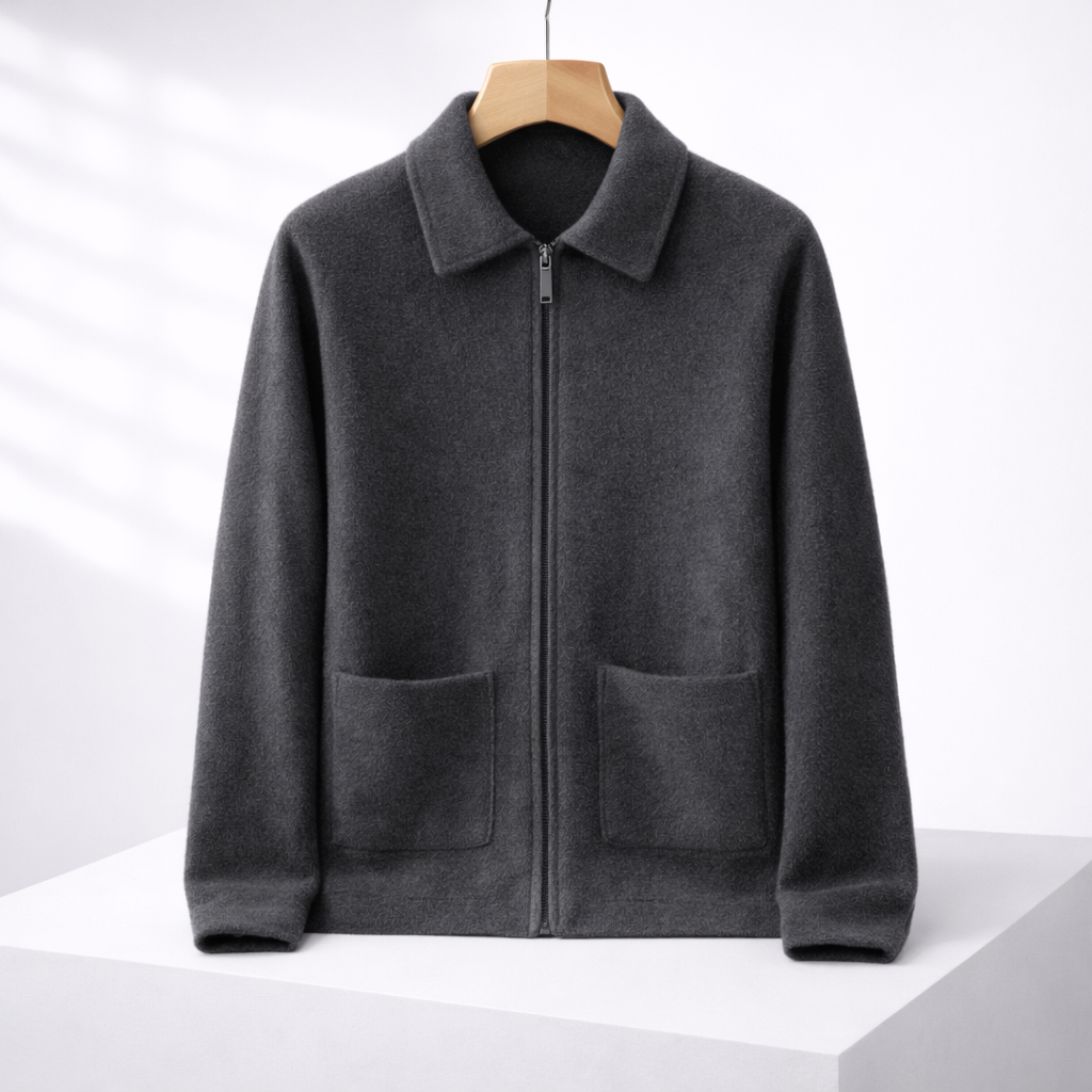 Dark gray men's cashmere zip-up sweater jacket with spread collar, two front patch pockets, on wooden hanger.
