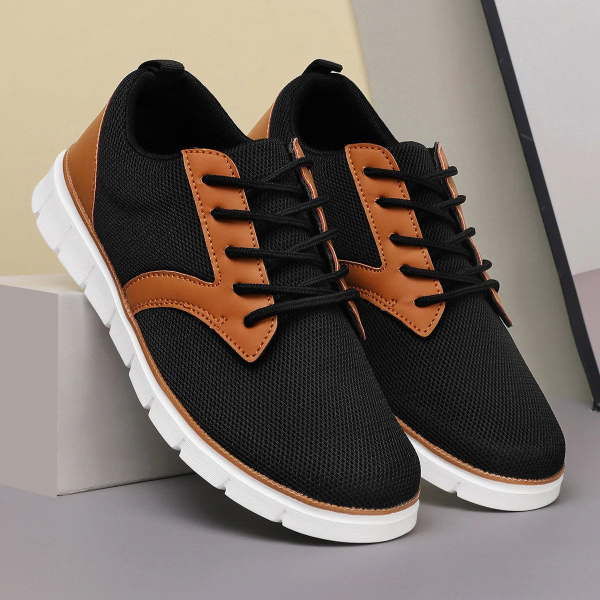 Black and tan canvas leather orthopedic sneakers with lace-up closure and white cushioned sole for women.