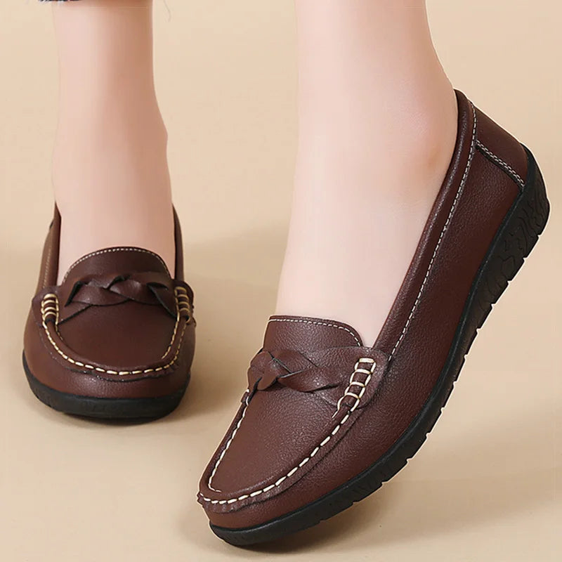 Women's brown leather slip-on loafers with braided detail and white contrast stitching on black sole