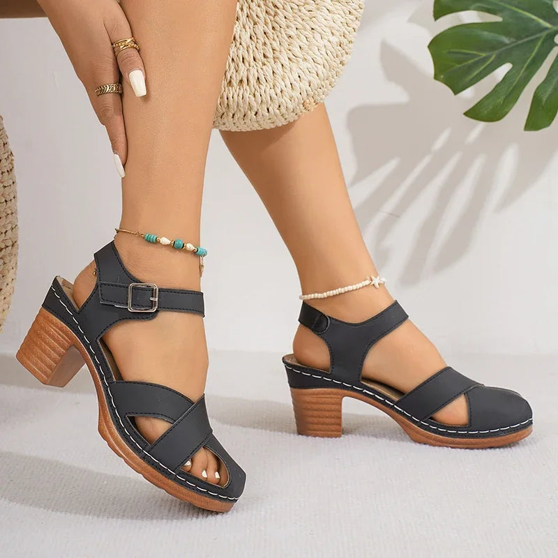 Black block heel ankle strap platform sandals with cutout toe design worn with beaded anklet bracelets