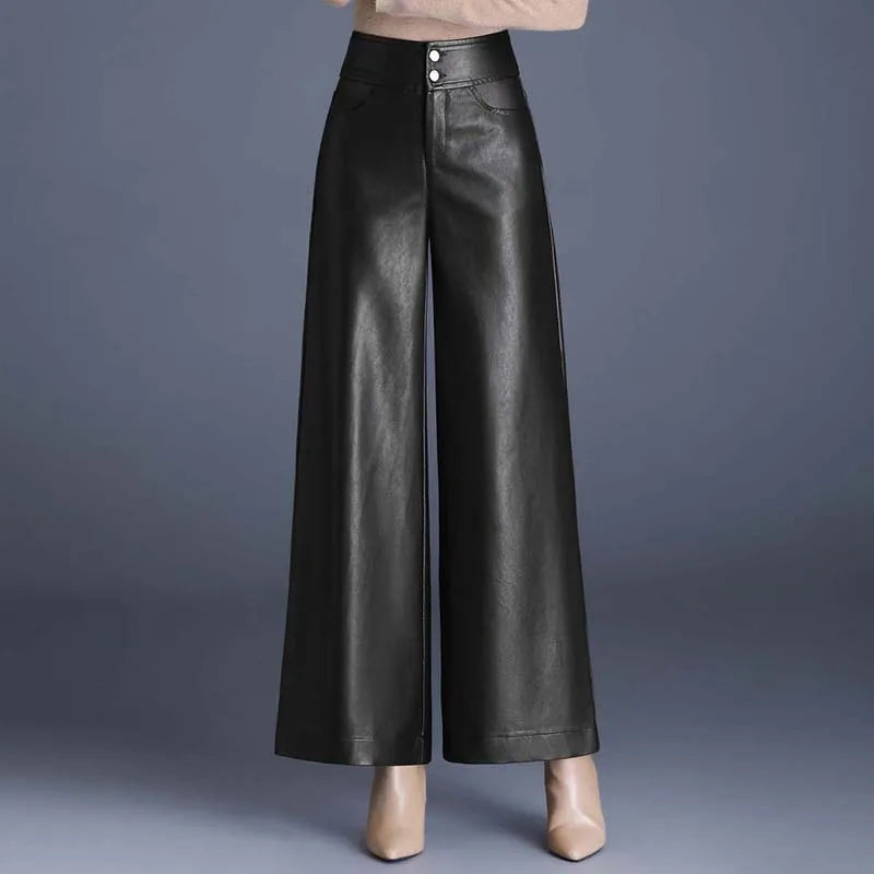 Black high-rise wide-leg vegan leather pants with double button closure, worn with beige heels and knit top.