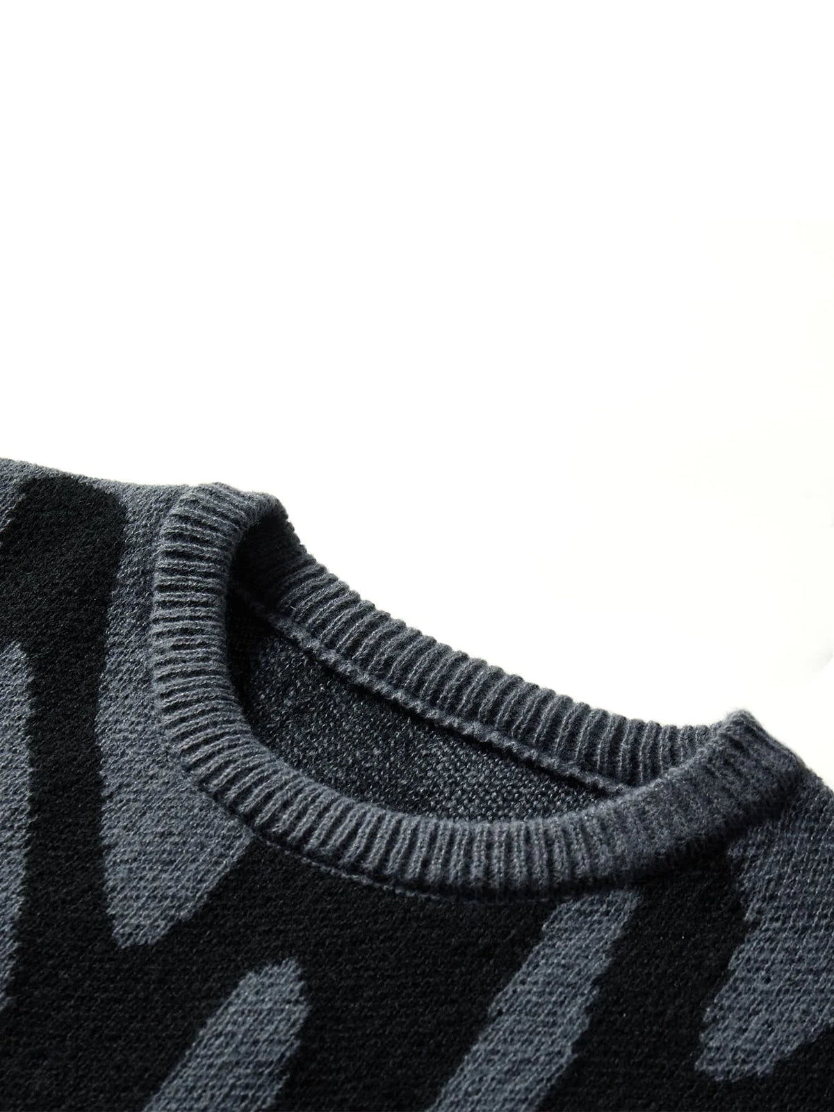 Dark gray wool knit oversized men's sweater with black abstract stripe pattern and ribbed crew neckline, close-up detail view.