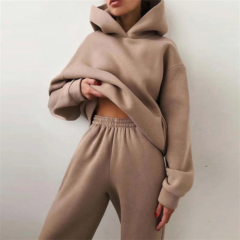 Women's oversized beige hoodie and sweatpants two-piece loungewear set against white background