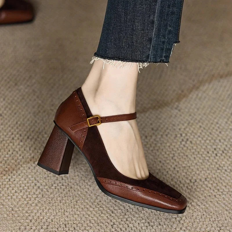 Brown leather Mary Jane block heel pumps with ankle strap buckle and square toe, worn with cropped jeans