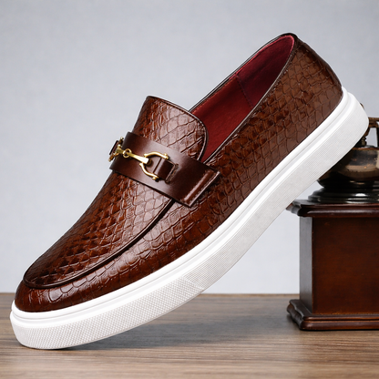 Brown textured leather slip-on loafers with gold horse bit buckle and white sole for men