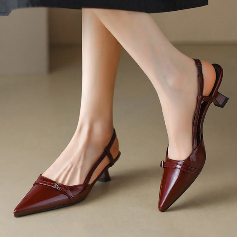 Women's burgundy pointed-toe slingback pumps with block heels and decorative buckle strap detail