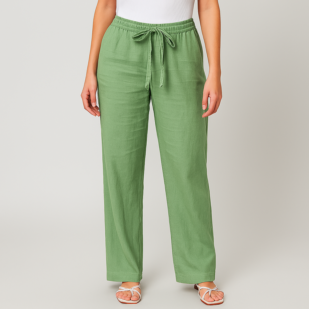 Women's sage green linen wide-leg pants with elastic drawstring waist, paired with white sandals and ribbed top.