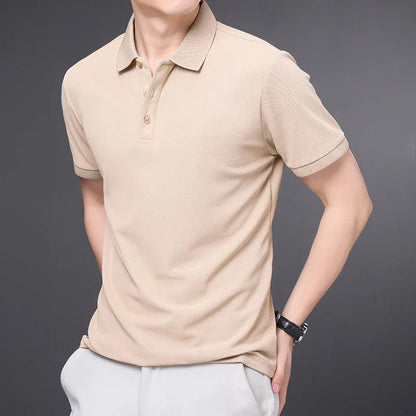 Men's beige short sleeve cotton polo shirt with collar and button placket on gray background