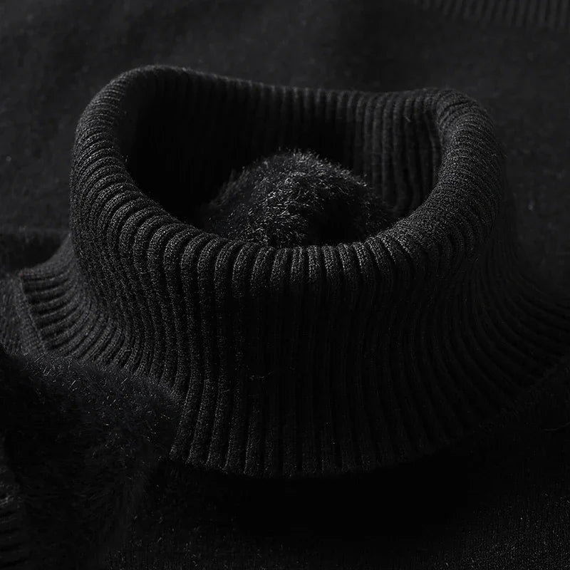 Black merino wool men's turtleneck sweater close-up showing ribbed collar detail and soft fleece interior lining.