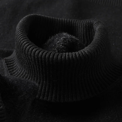Black merino wool men's turtleneck sweater close-up showing ribbed collar detail and soft fleece interior lining.