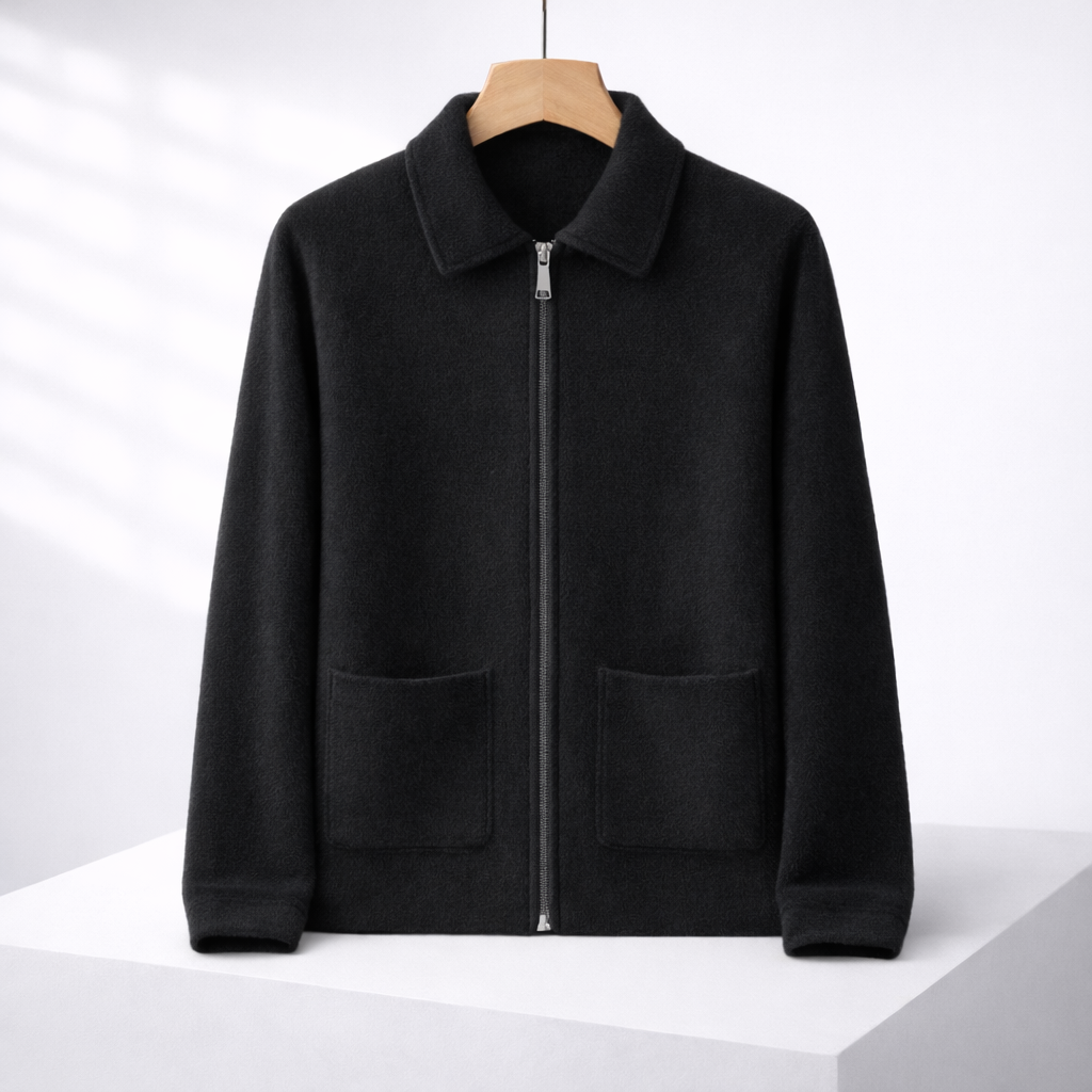 Black men's cashmere zip-up sweater jacket with spread collar, two front patch pockets, and ribbed cuffs and hem.