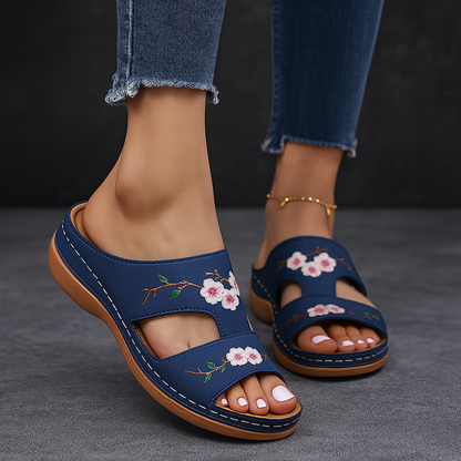 Women's navy blue platform sandals with pink floral embroidery, slip-on design, open toe, cushioned footbed