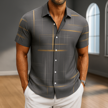 Men's dark gray short sleeve button-up shirt with gold geometric stripe print, worn with white pants.
