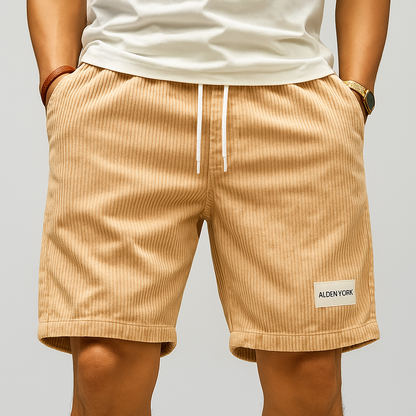 Men's tan corduroy drawstring shorts with white tie waist, side pockets, and Alden York label on left leg.