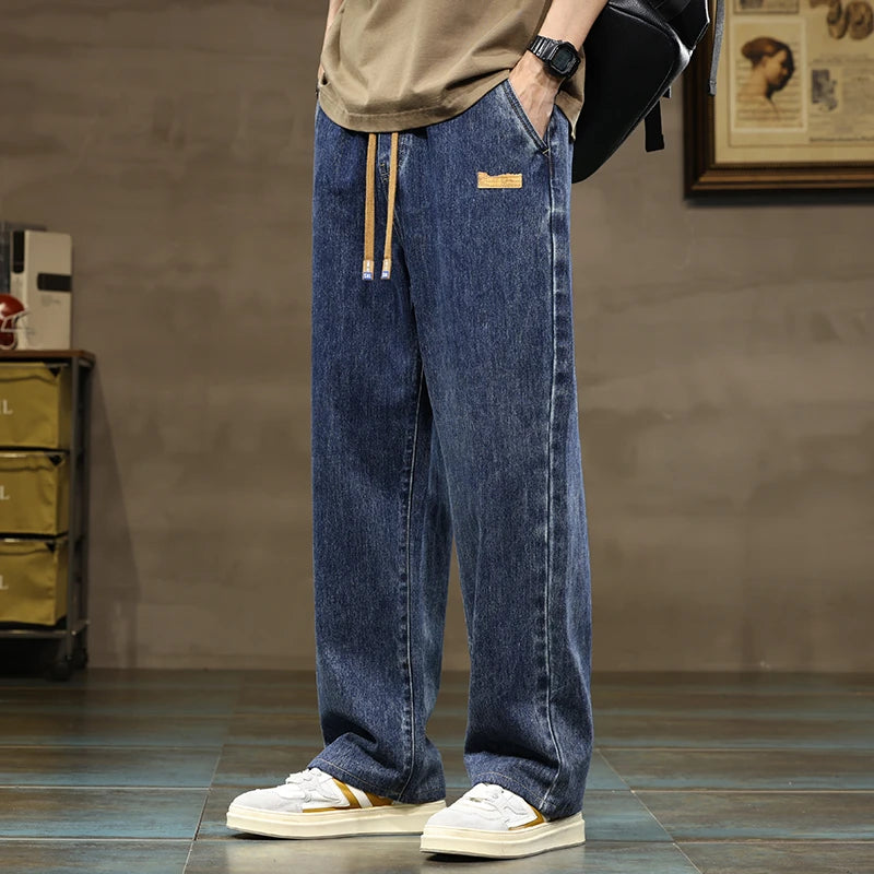 Men's wide-leg drawstring denim jeans in blue wash with elastic waistband and relaxed fit casual streetwear style