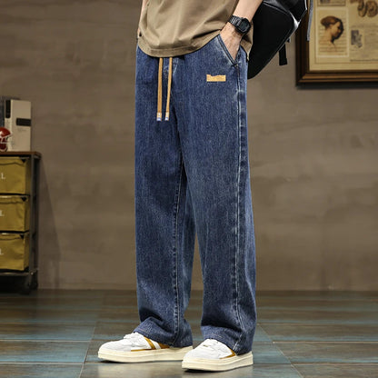 Men's wide-leg drawstring denim jeans in blue wash with elastic waistband and relaxed fit casual streetwear style