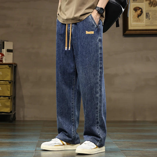 Men's wide-leg drawstring denim jeans in blue wash with elastic waistband and relaxed fit casual streetwear style