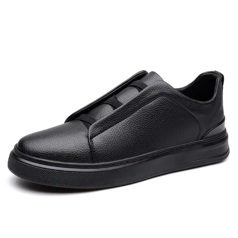 Black men's leather slip-on sneakers with elastic strap, pebbled texture upper, and thick rubber sole.