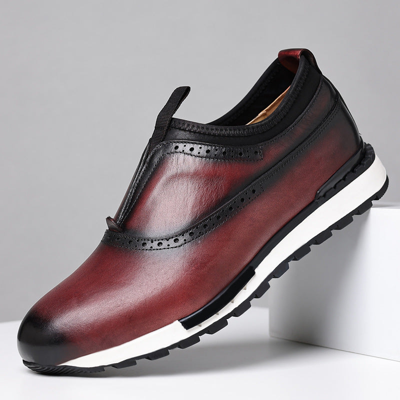 Men's burgundy leather slip-on loafers with brogue detailing, gradient finish, and white rubber sole on white platform.