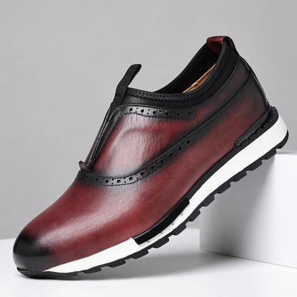 Men's burgundy leather slip-on loafers with brogue detailing, gradient finish, and white rubber sole on white platform.